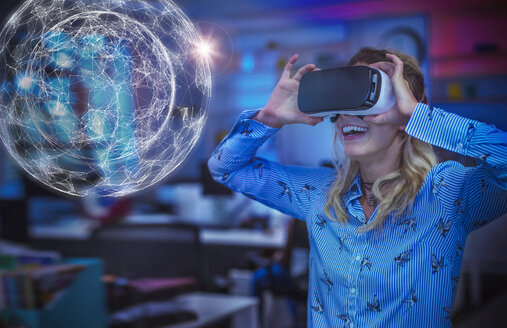 Begeisterte Computerprogrammiererin testet Virtual-Reality-Simulator-Brille und betrachtet futuristisches Hologramm - CAIF20589