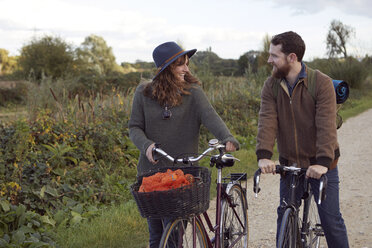 Couple enjoying cycling on marshes - CUF09946