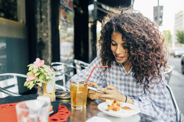 Woman at pavement cafe, Milan, Italy - CUF10053