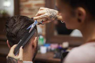 Hairdresser cutting customer's hair - CUF10196