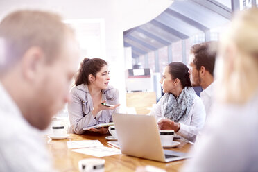 Over shoulder view of businessmen and women at office meeting - CUF10255