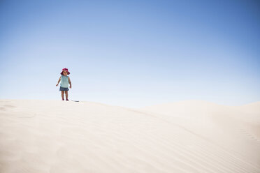Female toddler standing on top of sand dune, Little Sahara, Utah, USA - CUF10328