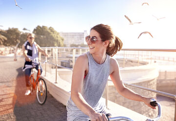 Frau fährt Fahrrad auf der Promenade - CUF10385