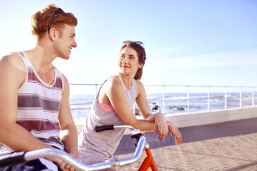 Couple on bicycles on promenade - CUF10387