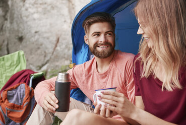 Couple camping, sitting by tent, Krakow, Malopolskie, Poland, Europe - CUF10506