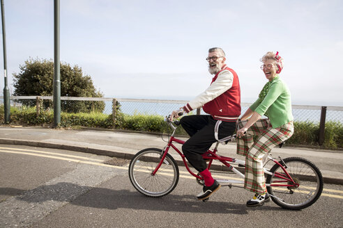 Skurriles Paar beim Sightseeing auf dem Tandem, Bournemouth, England - CUF11293