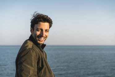 Portrait of smiling young man at the beach - AFVF00482