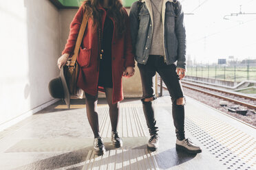 Portrait of young couple on train platform, low section - CUF11521