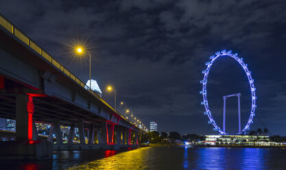 Blue ferris wheel on Marina Bay waterfront at night, Singapore, South East Asia - CUF11597