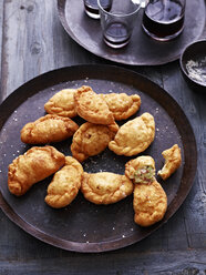 Deep fried calzone on serving plate, elevated view - CUF11626