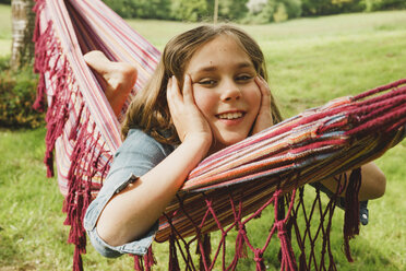 Portrait of smiling girl relaxing in hammock - ANHF00044