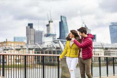 UK, London, young couple walking on bridge watching something - WPEF00275