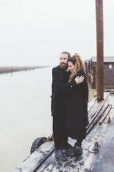 Couple hugging on misty canal waterfront - CUF11906