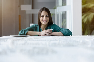 Porträt einer jungen Geschäftsfrau im Empfangsbereich eines Büros mit Smartphone und digitalem Tablet - CUF12005