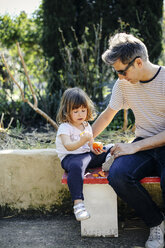 Father and little girl enjoying orange - CUF12181