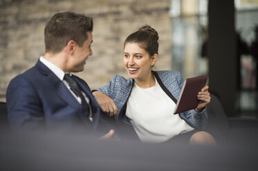 Businesswoman and man meeting on office sofa - CUF12288