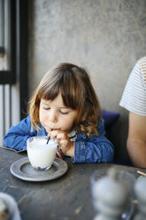 Girl sipping milk in cafe - CUF12596