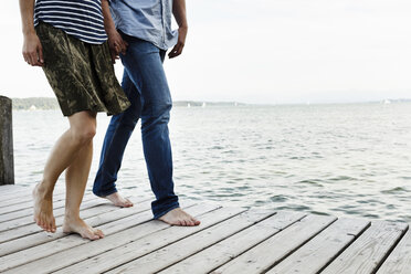 Cropped view of romantic couple strolling on wooden pier, Lake Starnberg, Bavaria, Germany - CUF12959