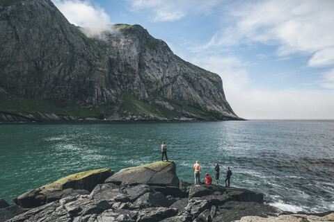 Norway, Lofoten, Moskenesoy, Young men fishing at Horseid Beach stock photo