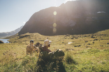 Norway, Lofoten, Moskenesoy, Young men resting at Litljordtinden - GUSF00879