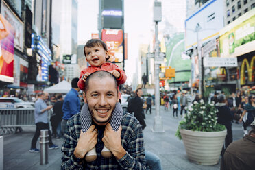 USA, New York, New York City, Times Square, Father with baby on shoulders - GEMF01998
