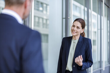 Portrait of smiling businesswoman face to face to business partner - DIGF04309