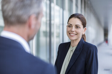 Portrait of smiling businesswoman face to face to business partner - DIGF04310