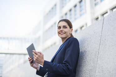 Portrait of smiling businesswoman with tablet - DIGF04324