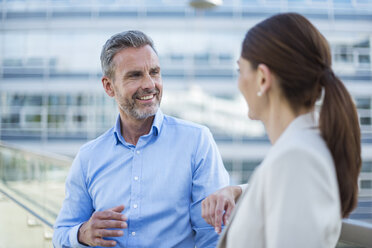 Portrait smiling businessman face to face to his business partner - DIGF04335