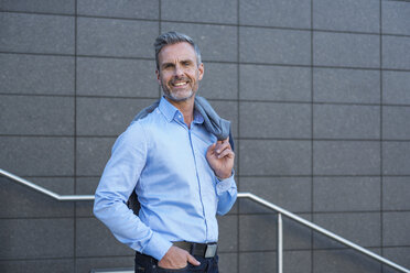 Portrait of content businessman wearing light blue shirt - DIGF04338