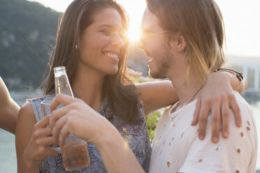 Happy young couple at sunset roof terrace party, Budapest, Hungary - ISF02195