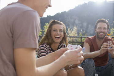 Erwachsene Freunde haben Spaß beim Kartenspielen auf einer Dachterrassenparty - ISF02225