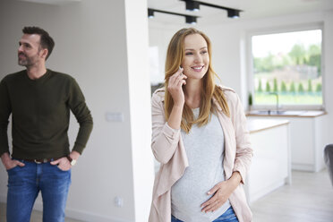 Couple looking around in empty flat - ABIF00441