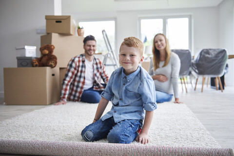 Portrait of happy family moving into new flat stock photo