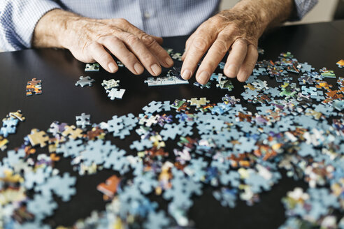 Senior man doing a jigsaw - JRFF01675