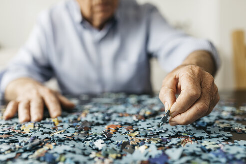 Senior man doing a jigsaw - JRFF01676