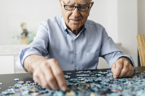 Senior man doing a jigsaw - JRFF01677