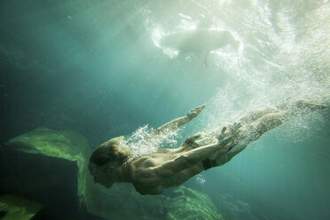 Young man swimming underwater - ISF02652