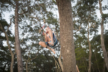 Junge schwingt an einem Seil im Baum - ISF02680