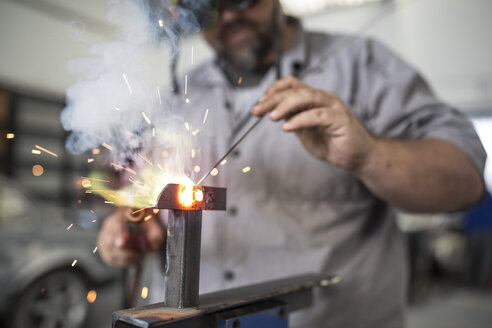 Man welding in bodywork repair shop - ISF02772