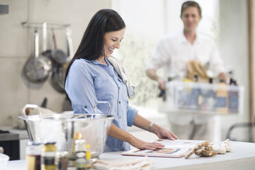 Husband and wife making preparations in kitchen - ISF02869