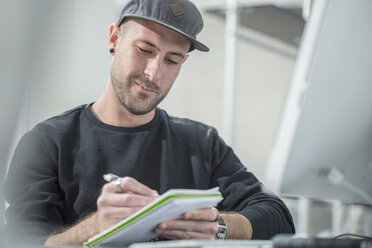 Man writing in notepad - ISF02953