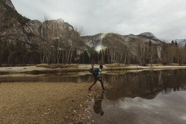 Male hiker hiking by lake, Yosemite National Park, California, USA - ISF02969