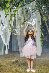 Portrait of young girl, dressed as fairy, dancing outdoors - ISF03024