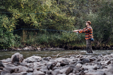 Man wading in river, fishing - ISF03675