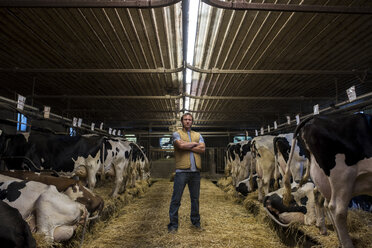 Portrait of farmer in cow shed - ISF03764