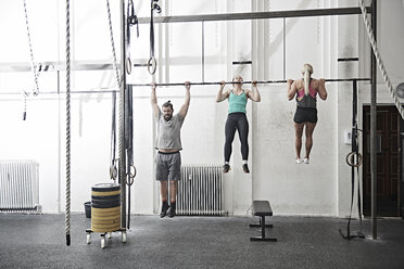 Freunde machen Klimmzüge im Cross-Training-Fitnessstudio - ISF04060