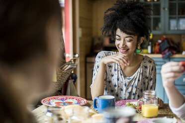 Three friends sitting around table, eating breakfast - ISF04161