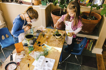 Two girls doing science experiments at messy table - ISF04298