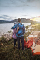 Couple standing beside tent, looking at view, Heeney, Colorado, United States - ISF04413